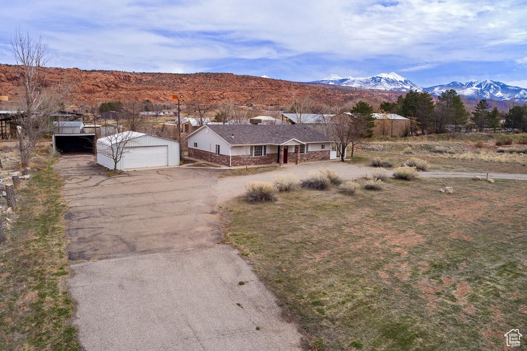 View of front of property featuring a garage and a mountain view