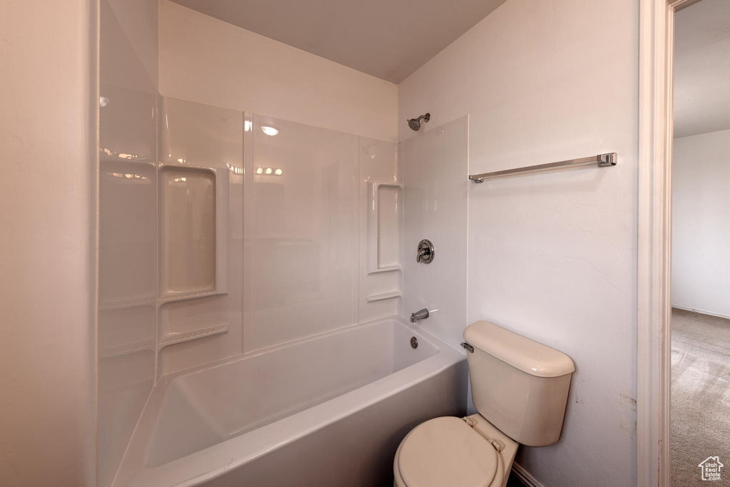 Bathroom featuring shower / bath combination and toilet