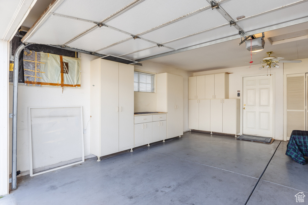 Garage with a garage door opener and ceiling fan
