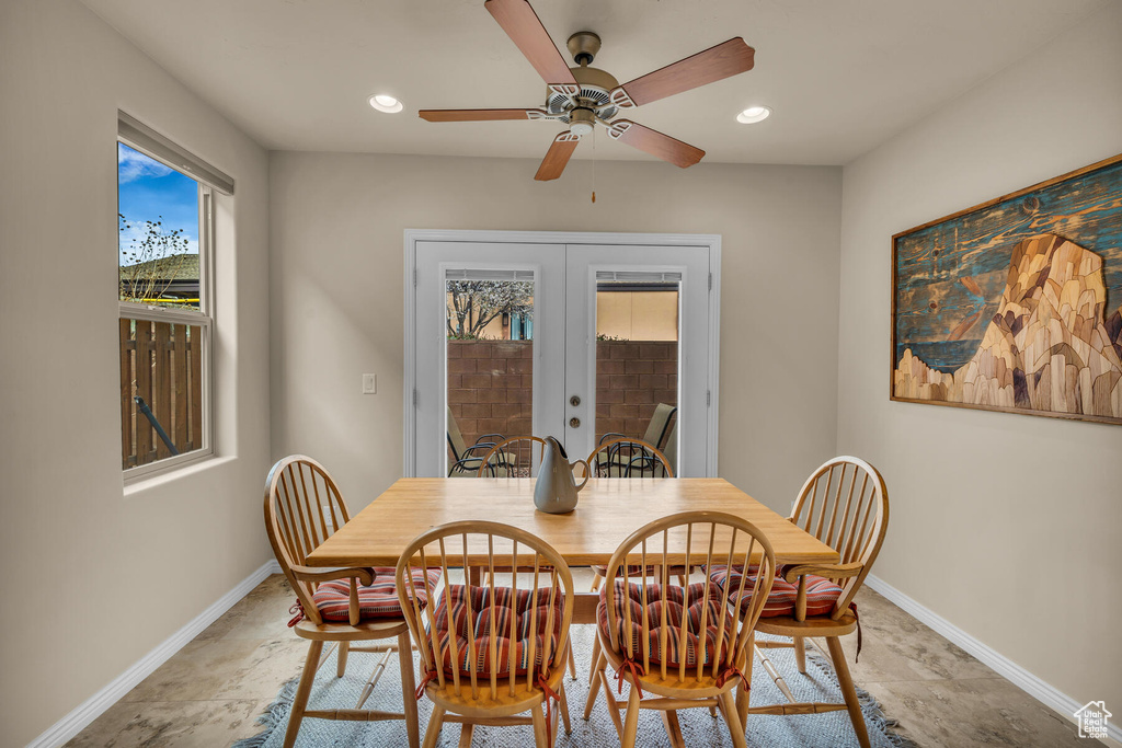 Dining room with ceiling fan, light tile flooring, and french doors