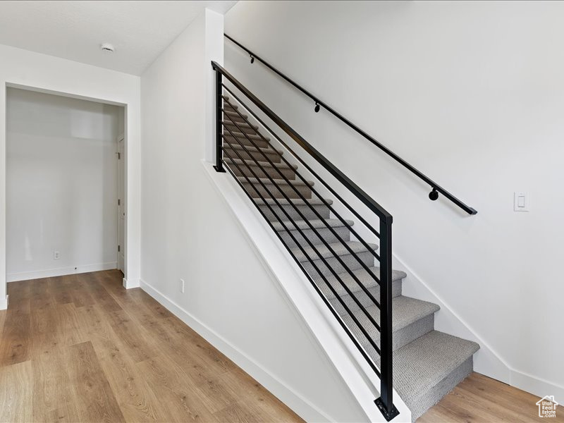 Staircase featuring light hardwood / wood-style floors