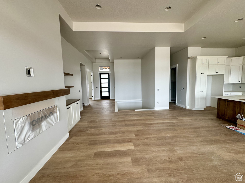 Interior space featuring white cabinets and light hardwood / wood-style floors