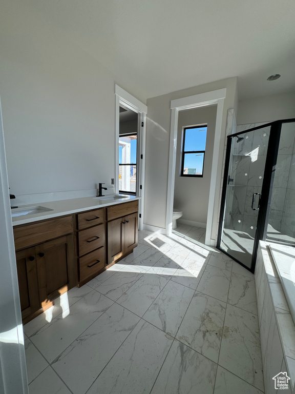 Full bathroom featuring plus walk in shower, tile floors, dual sinks, toilet, and large vanity