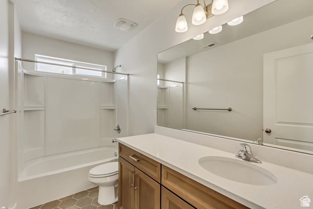Full bathroom with vanity, toilet, tile floors, and bathing tub / shower combination
