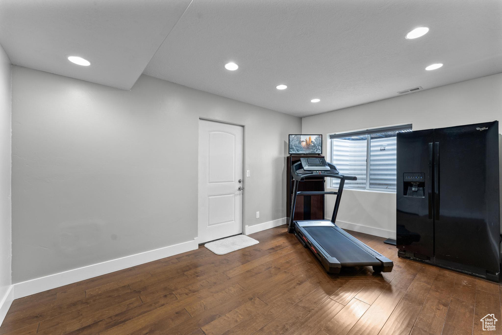 Workout room featuring dark hardwood / wood-style floors