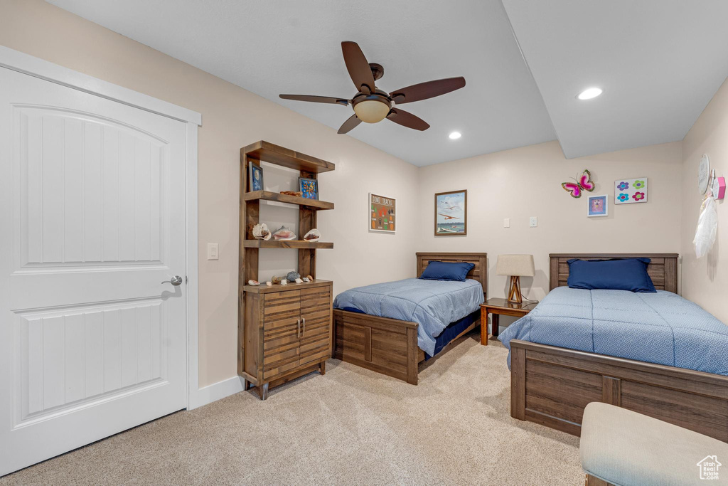Bedroom featuring light colored carpet and ceiling fan