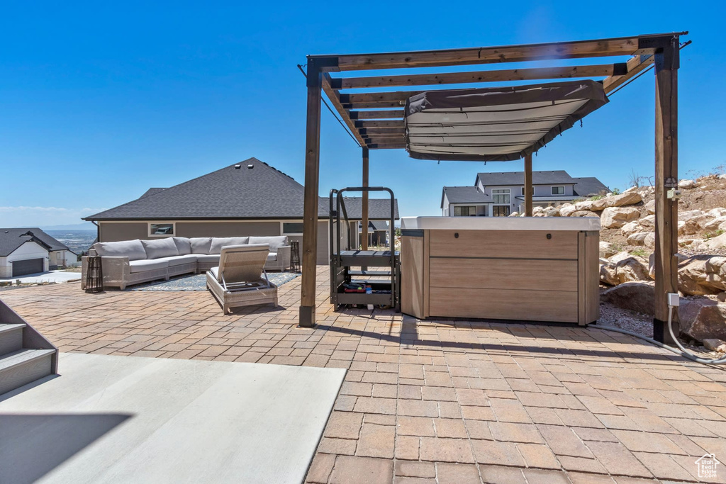 View of patio / terrace with outdoor lounge area, a hot tub, and a pergola