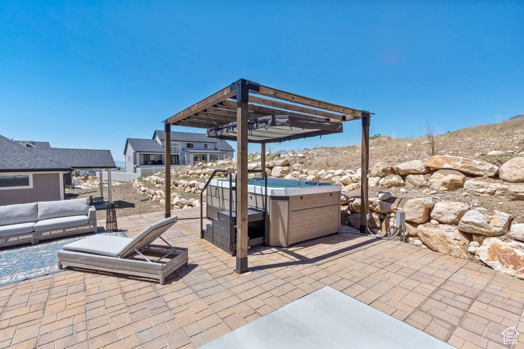 View of patio / terrace featuring a pergola, a hot tub, and outdoor lounge area