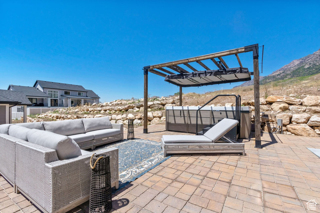 View of patio featuring a pergola and an outdoor hangout area