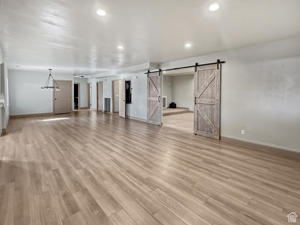 Interior space featuring light hardwood / wood-style flooring and a barn door