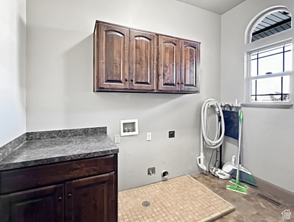 Laundry room featuring cabinets, washer hookup, and hookup for an electric dryer