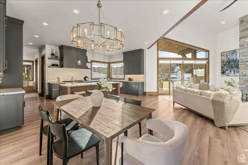 Dining space featuring an inviting chandelier, light hardwood / wood-style flooring, and plenty of natural light