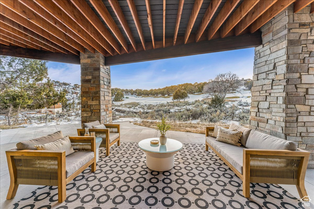 Snow covered patio with outdoor lounge area