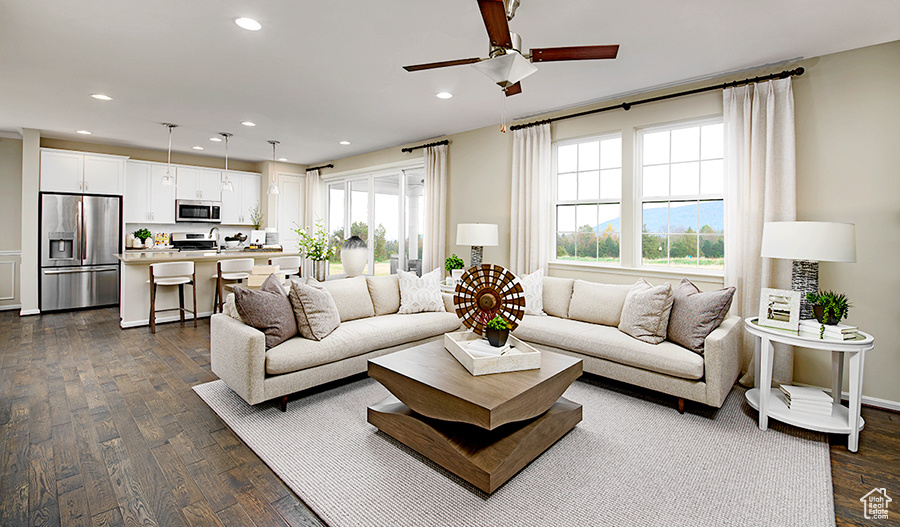 Living room with dark wood-type flooring and ceiling fan
