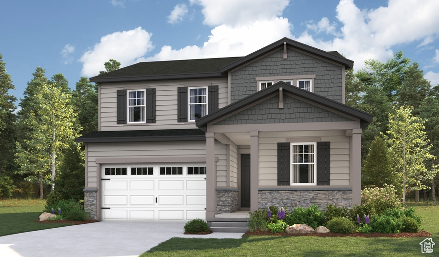 Craftsman inspired home featuring a front lawn and a garage