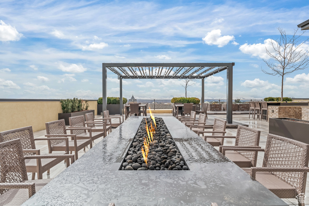 View of patio / terrace with a pergola and an outdoor fire pit
