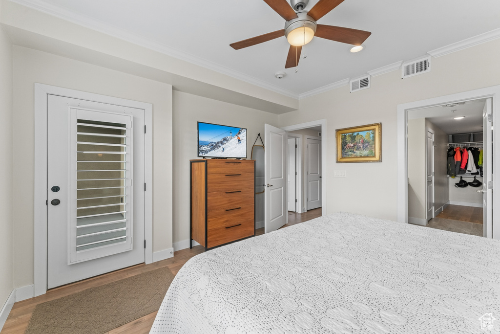 Bedroom with access to exterior, ornamental molding, a closet, light wood-type flooring, and ceiling fan