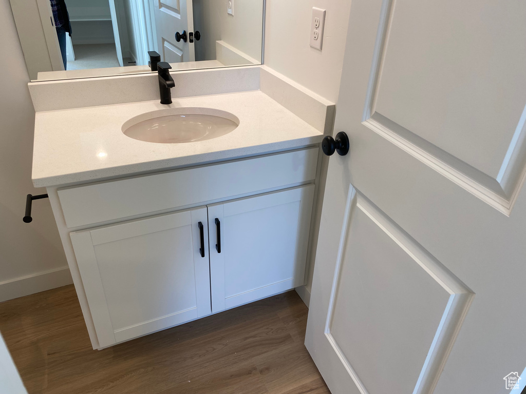 Bathroom featuring vanity and hardwood / wood-style floors