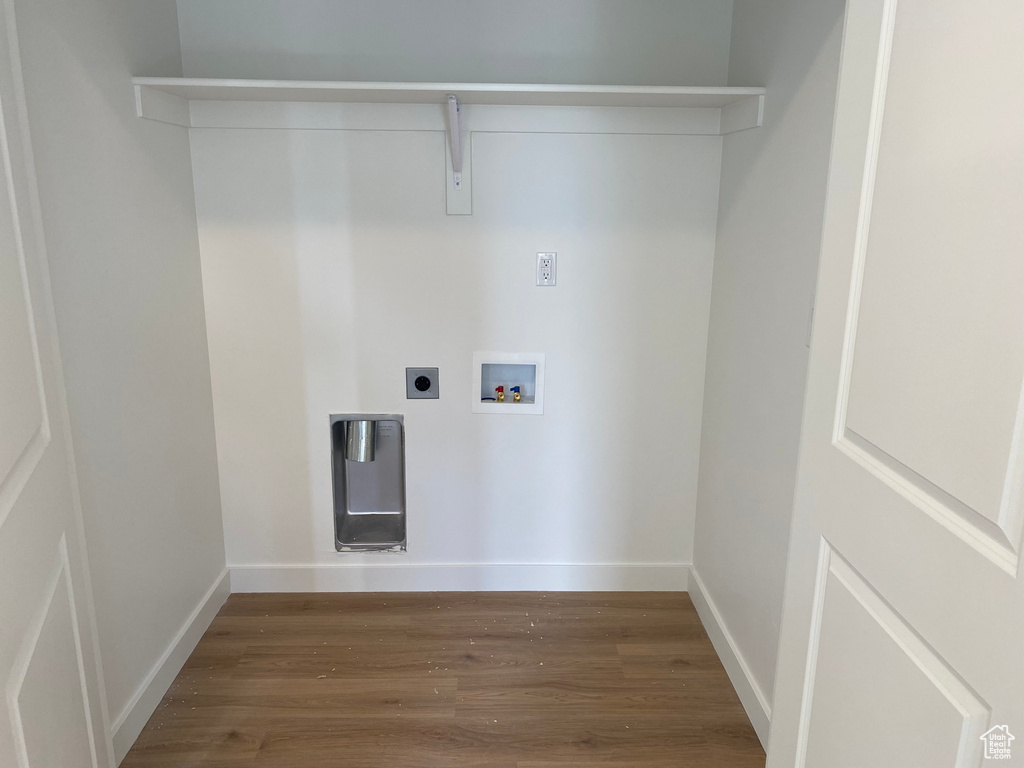 Clothes washing area with hookup for an electric dryer, dark hardwood / wood-style floors, and hookup for a washing machine