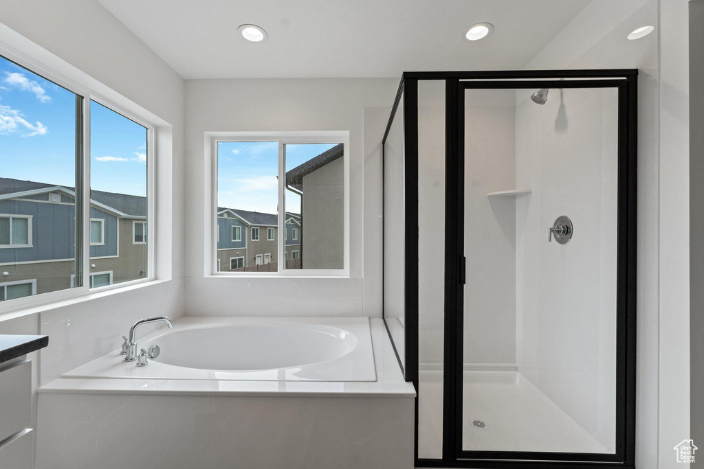 Bathroom with vanity and shower with separate bathtub