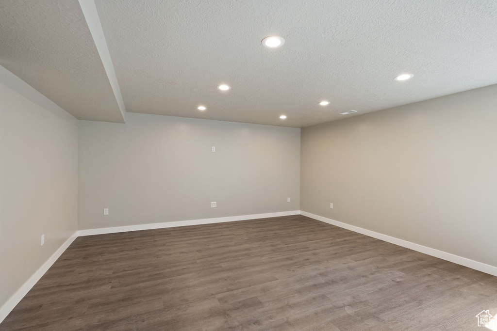 Empty room featuring hardwood / wood-style floors and a textured ceiling