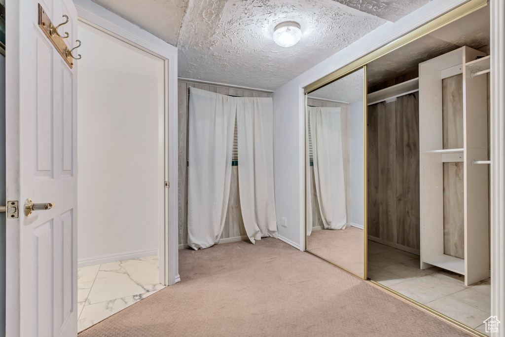 Spacious closet featuring light tile flooring
