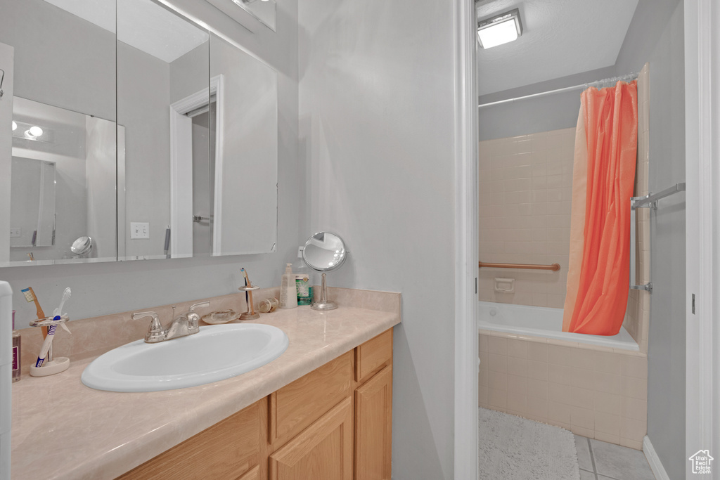 Bathroom with vanity, tile flooring, and shower / bath combo