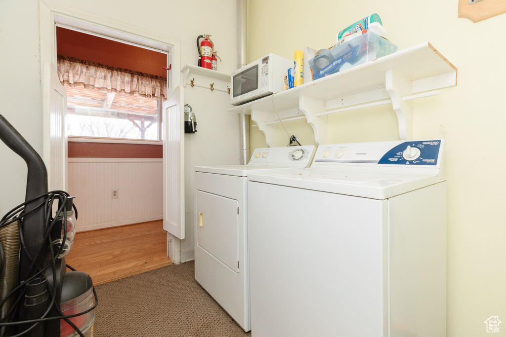 Washroom with carpet flooring and separate washer and dryer