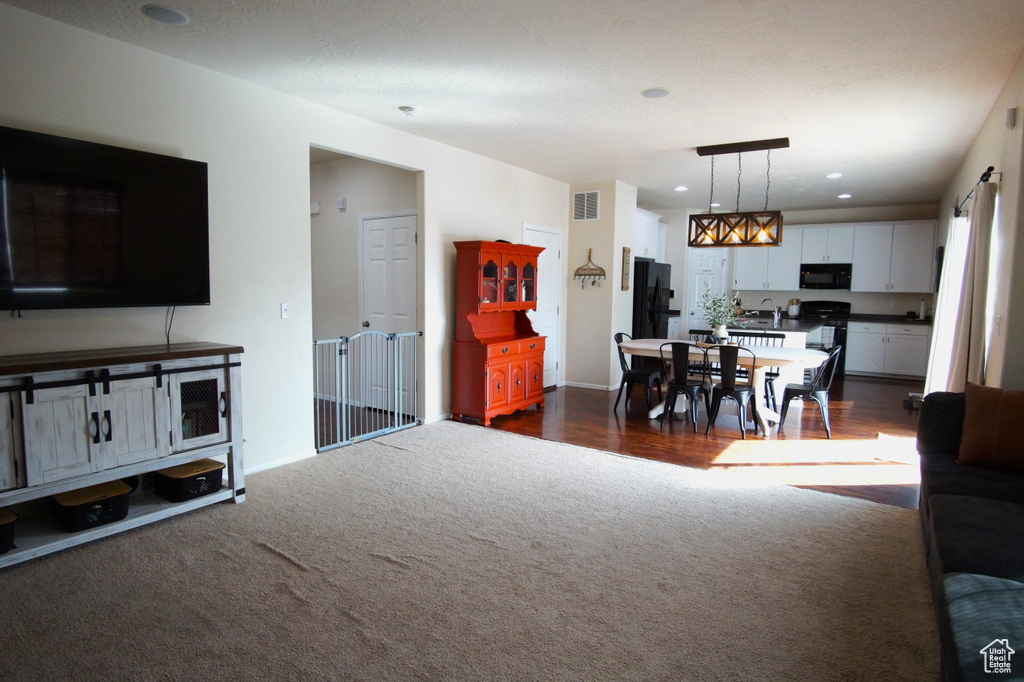 Living room featuring dark colored carpet