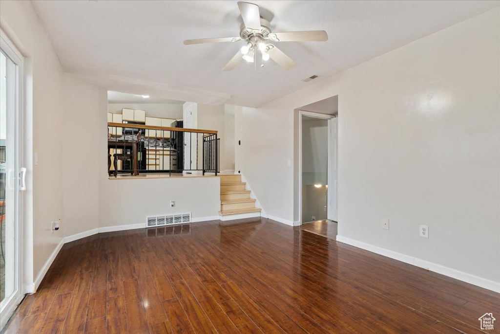 Spare room with ceiling fan and dark hardwood / wood-style floors