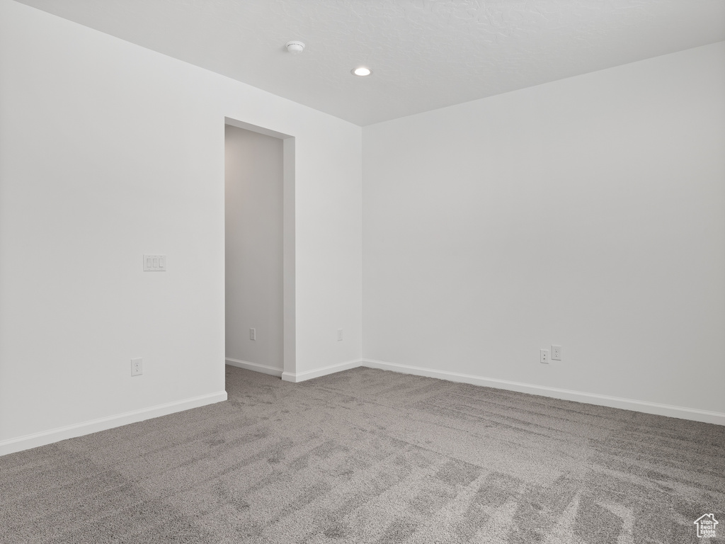 Empty room featuring light colored carpet