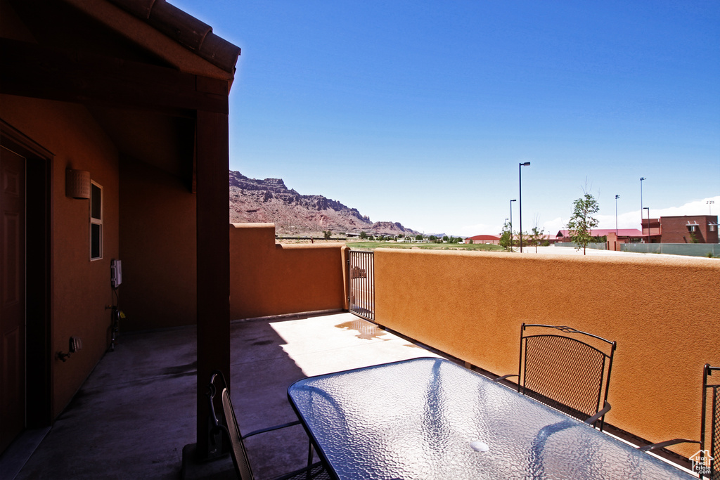 View of patio / terrace with a mountain view and a balcony