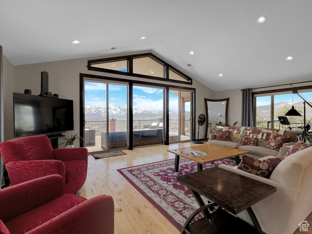 Living room featuring light hardwood / wood-style floors and lofted ceiling