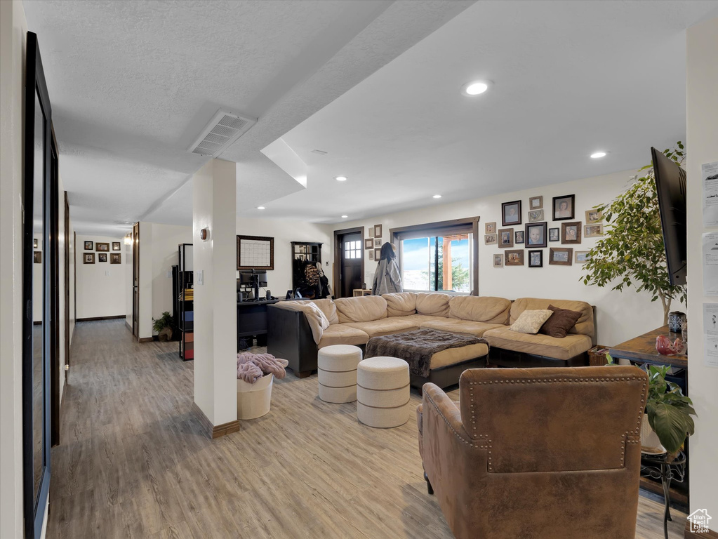Living room featuring hardwood / wood-style flooring and a textured ceiling