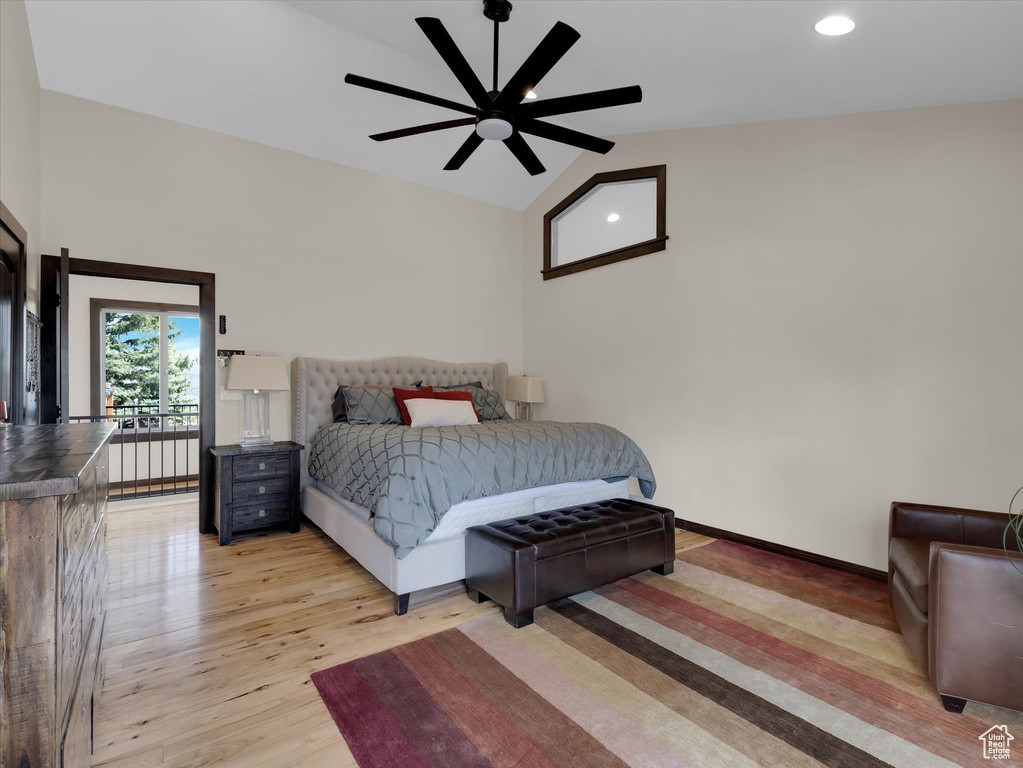 Bedroom with light hardwood / wood-style flooring, ceiling fan, and vaulted ceiling