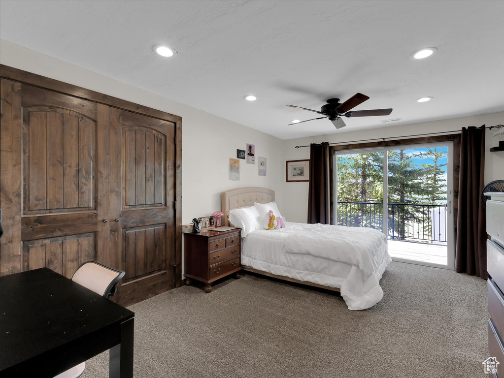 Carpeted bedroom with ceiling fan and access to outside