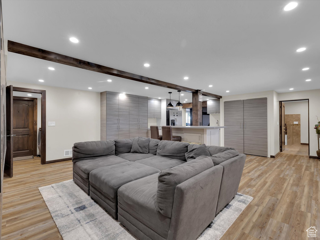 Living room featuring light hardwood / wood-style flooring and tile walls