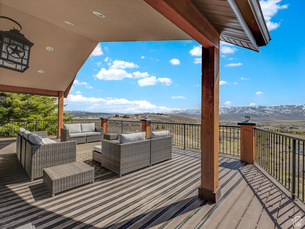 Wooden deck with a mountain view and outdoor lounge area