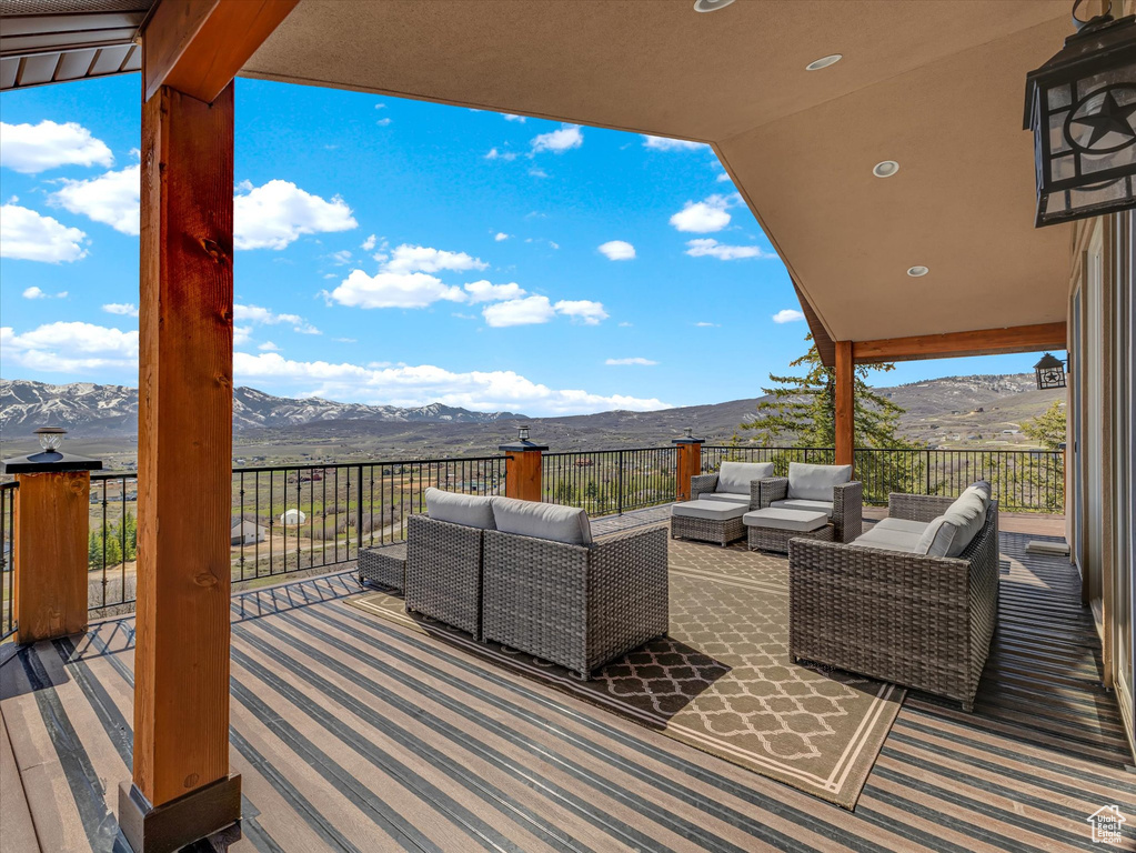 Wooden deck featuring an outdoor living space and a mountain view