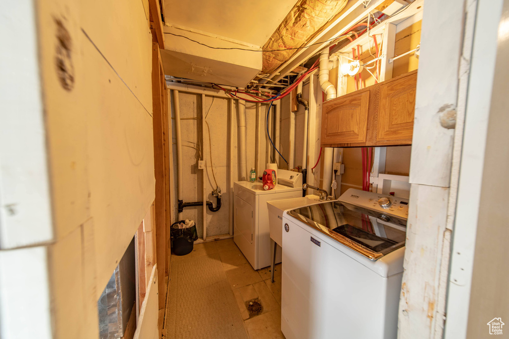 Laundry area featuring cabinets and independent washer and dryer