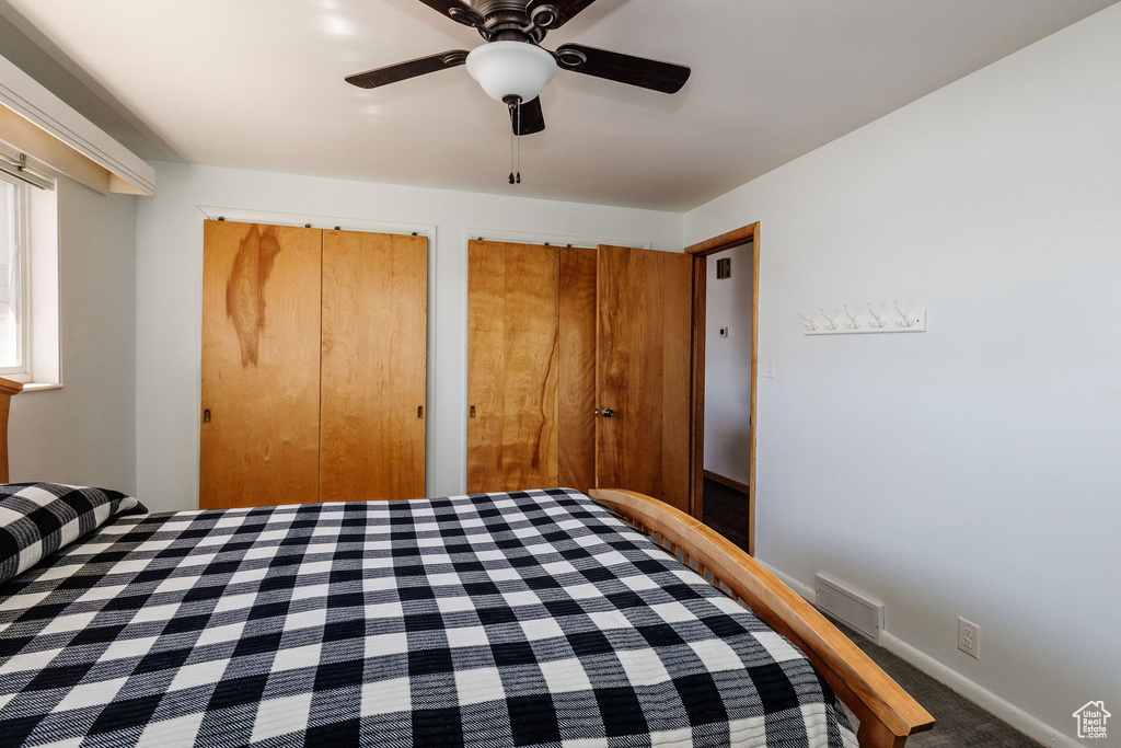 Bedroom featuring multiple closets and ceiling fan