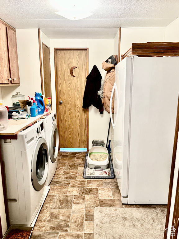 Laundry area with cabinets, washer and clothes dryer, and light tile floors