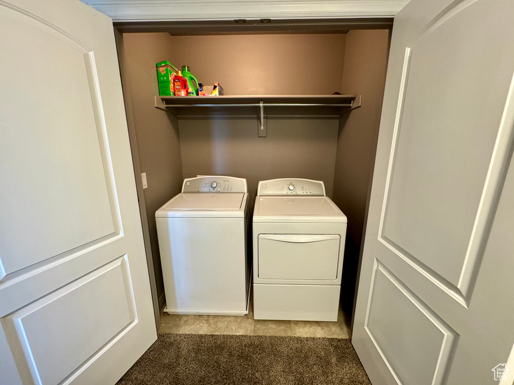 Laundry room featuring washing machine and dryer and carpet