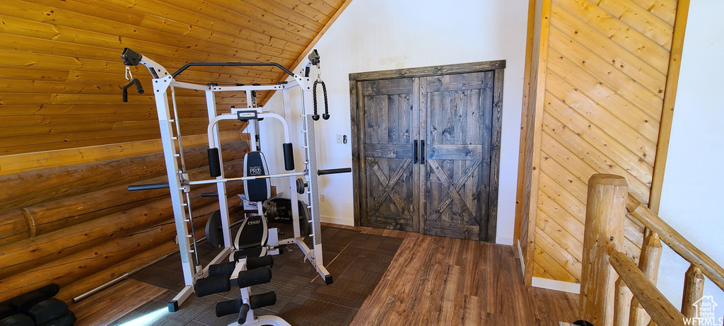 Exercise area with vaulted ceiling, wooden ceiling, and dark wood-type flooring