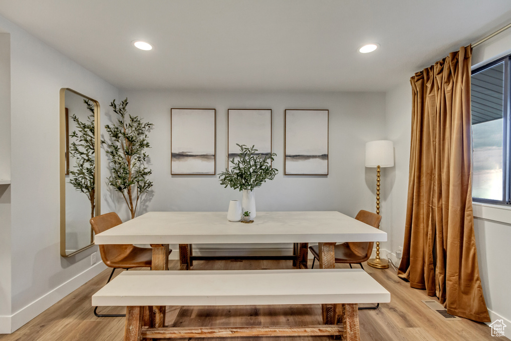 Dining area with light hardwood / wood-style floors