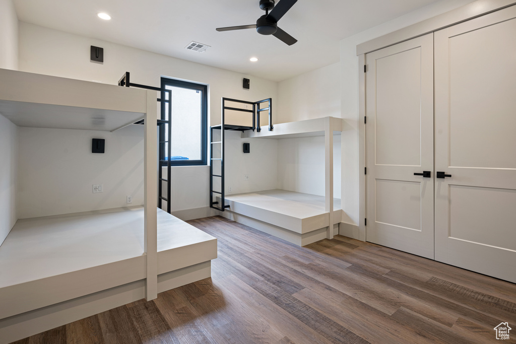 Unfurnished bedroom with a closet, ceiling fan, and hardwood / wood-style floors
