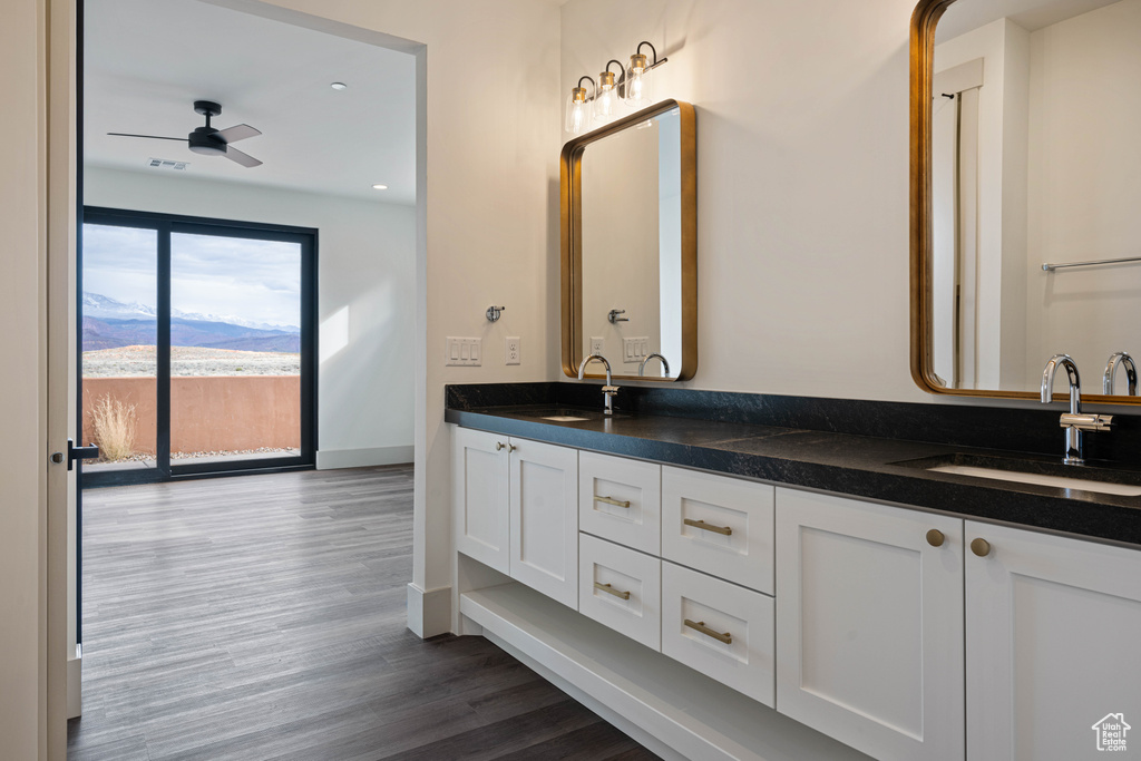 Bathroom featuring hardwood / wood-style flooring, double vanity, and ceiling fan