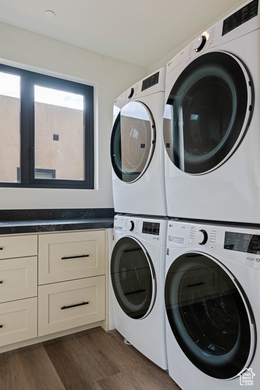 Clothes washing area featuring stacked washer / drying machine, separate washer and dryer, dark hardwood / wood-style flooring, and cabinets