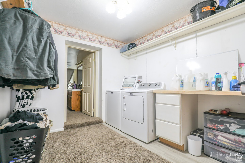 Laundry room with hookup for a washing machine and washer and clothes dryer