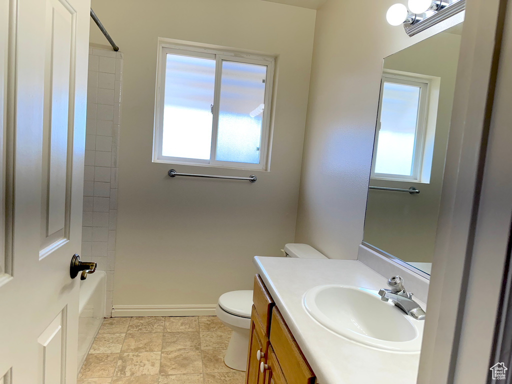 Full bathroom featuring tile flooring, shower / bathing tub combination, toilet, and vanity